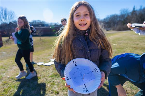 girl with sundial smiling